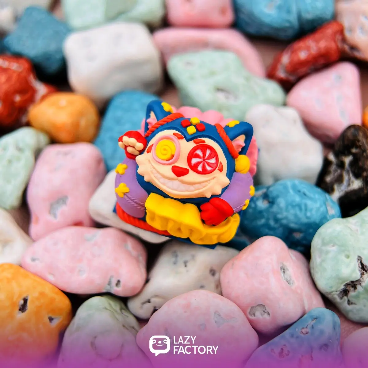 Lolipop Meowhe artisan keycap resting on colorful candy stones