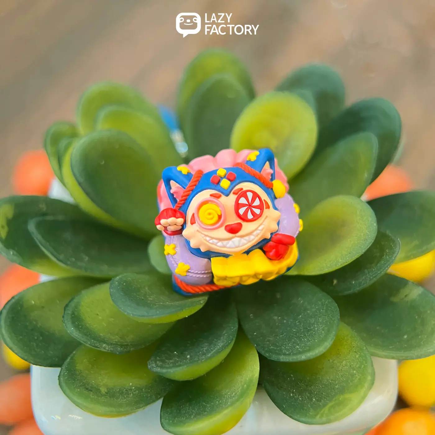 Lolipop Meowhe artisan keycap nestled in green succulent leaves