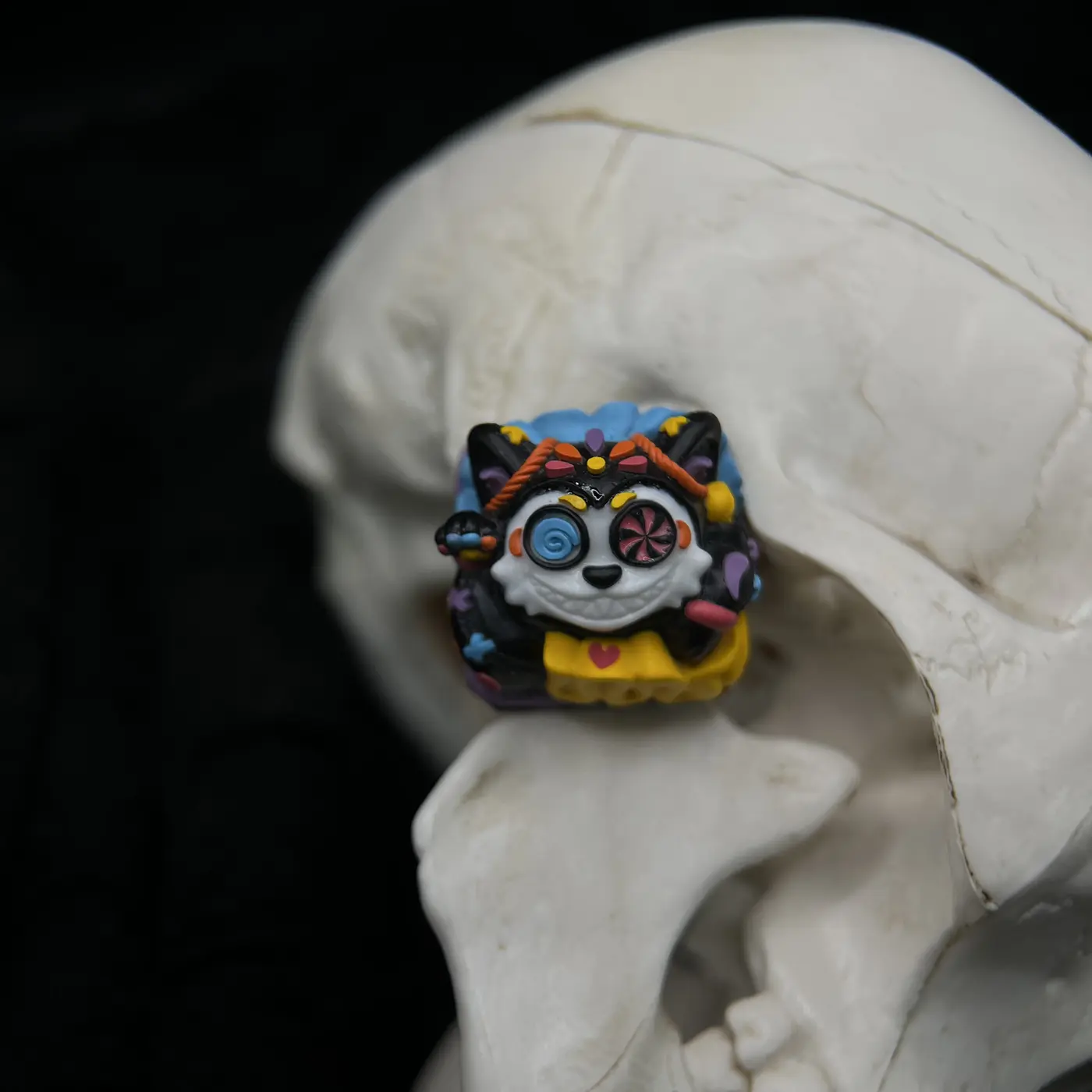 Mictlán artisan keycap centered against a pale skull